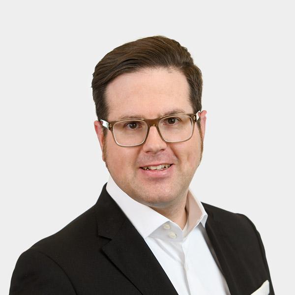 Michael Breitling, Partner Portraetfoto von Michael Breitling vor grauem Hintergrund