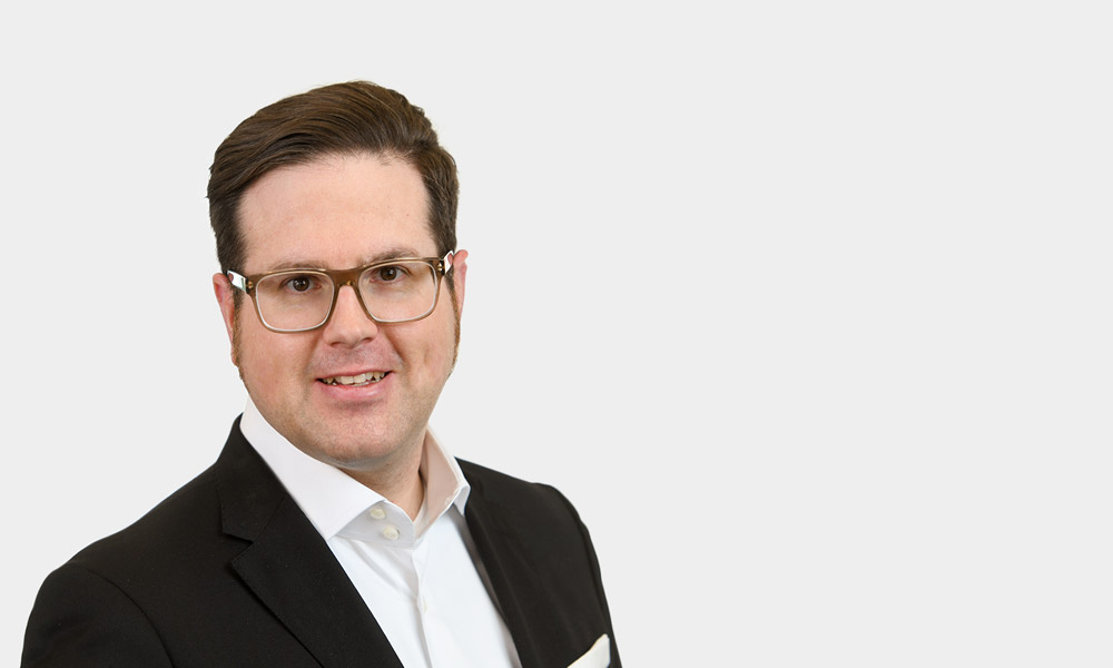 Michael Breitling, Partner Portraetfoto von Michael Breitling vor grauem Hintergrund