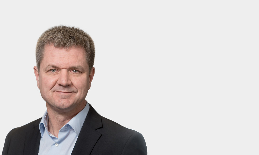 Ulrich Krieg, Partner Portraetfoto von Ulrich Krieg vor grauem Hintergrund